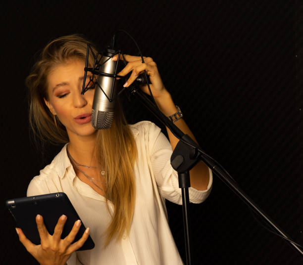 istock Caucasian European woman singing bro microphone in studio 1266995207