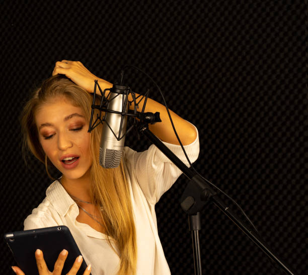 istock Caucasian European woman singing bro microphone in studio 1266995217