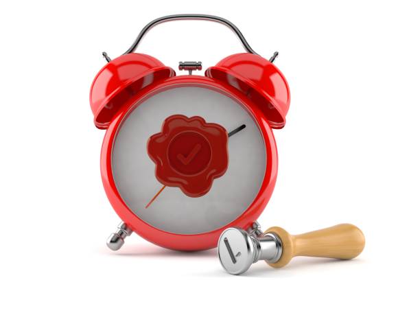 istock Alarm clock with wax seal stamp 1266996829