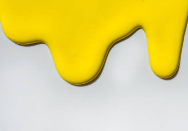 istock Yellow paint spreads on a white background. Copy space. 1266997688