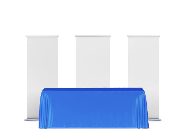 istock Blank tradeshow tablecloth with roll-up banners aside 1267002430
