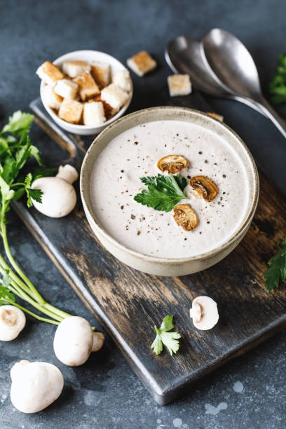 Mushroom cream soup on dark background. Mushroom soup Mushroom cream soup on dark background. Champignon soup cream soup stock pictures, royalty-free photos & images