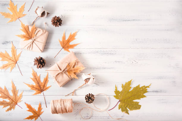 istock autumn yellow maple leaves, cones, thread on a white wooden background 1267002871