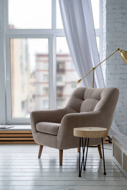 istock 1 beige chair  in a bright room with a window background 1267002967