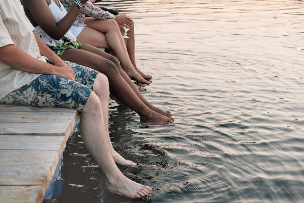 istock Friends sitting on a pier 1267003856