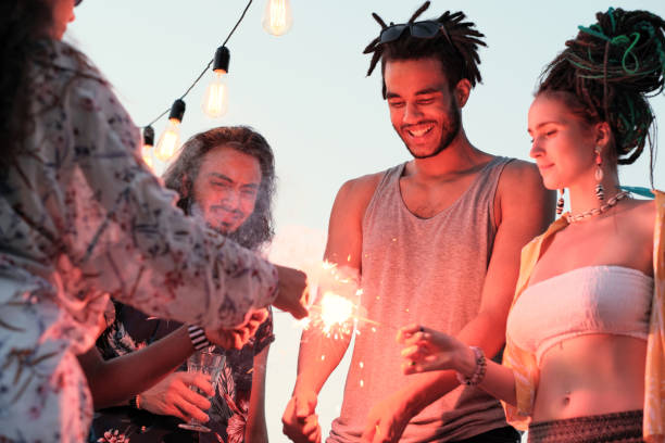istock People with sparklers at party 1267003959
