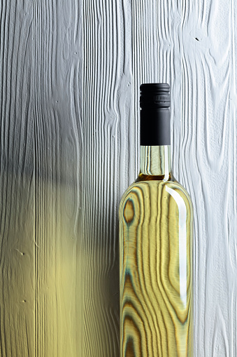 An unopened bottle of white wine on an old wooden background. Copy space.