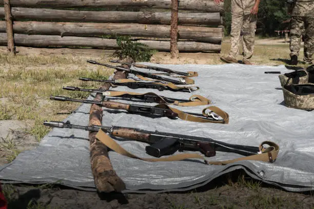 Photo of AK-74 submachine guns lie in a row on training places.