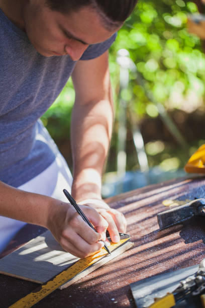 istock Man working like carpenter in his backyard during lockdown 1267006974