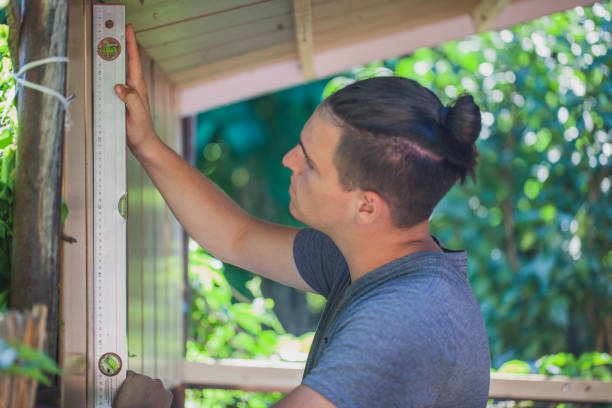 istock Man working and measure with level in his backyard 1267011102