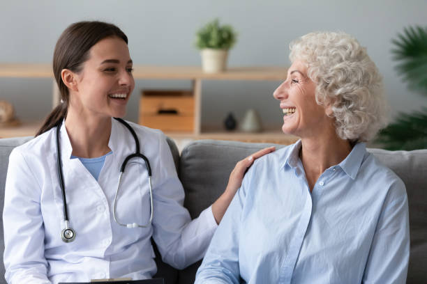 istock Happy young general practitioner touching shoulder of smiling patient. 1267012030