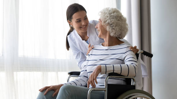 istock Professional young female medical worker communicating with disabled patient. 1267012058
