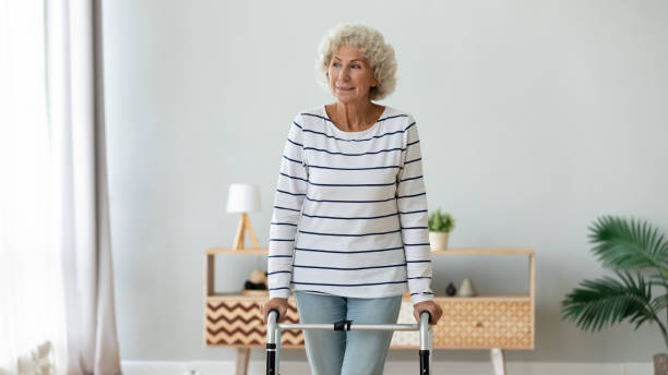 istock Smiling older disabled grandmother making steps with walker. 1267012078