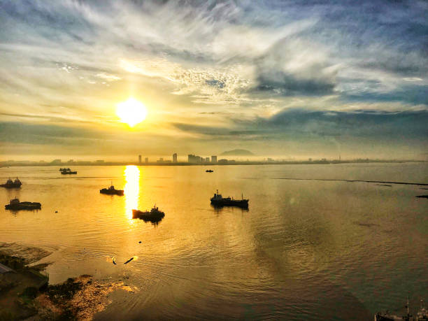 istock Sunset seen from Penang, Malaysia the yellow sun's rays create a beautiful golden surface effect on the water 1267012549