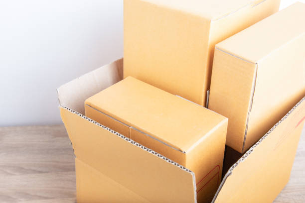 istock Top view and close up shot of stack boxes in different size from small to large shows beautiful lighting. They are on the wooden desk of online merchandise for selling stuff and delivery to customer. 1267013277
