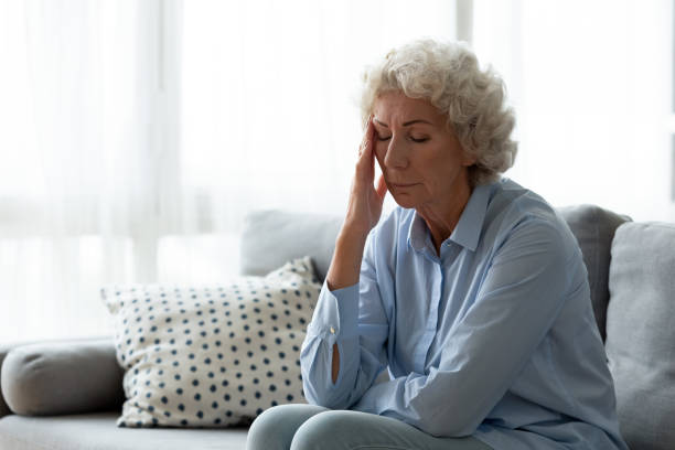 istock Exhausted mature woman suffering from headache indoors. 1267013557