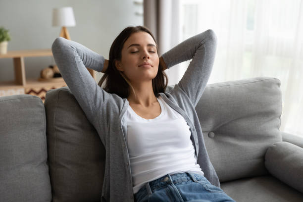 istock Young beautiful peaceful woman daydreaming on couch. 1267013576
