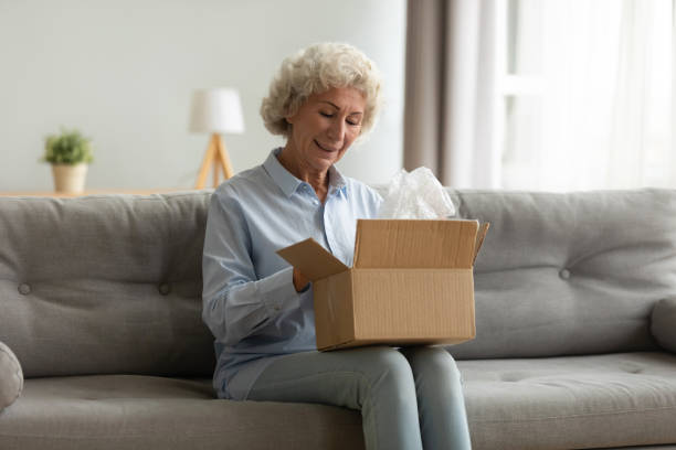 istock Smiling older female client satisfied with fast courier delivery service. 1267013584