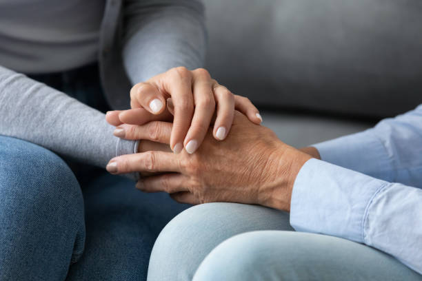 istock Young affectionate woman holding hands of elderly mother. 1267013599