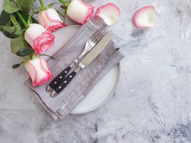 istock plate flower rose on concrete background 1267015714