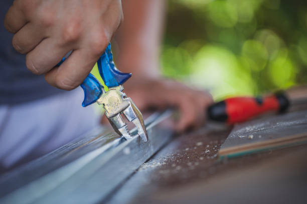 Man working with pliers like carpenter in his backyard