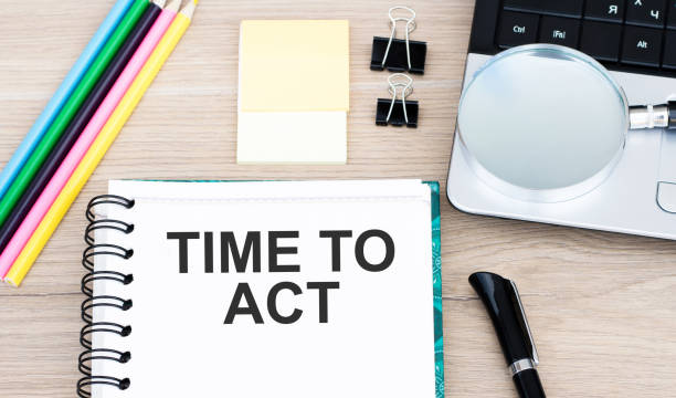 istock Notepad with text Time To Act on white background with clips, pen and magnifying glass 1267016100