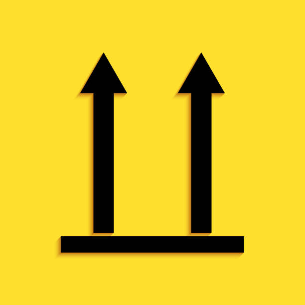 istock Black This side up icon isolated on yellow background. Two arrows indicating top side of packaging. Cargo handled so these arrows always point up. Long shadow style. Vector 1267017258