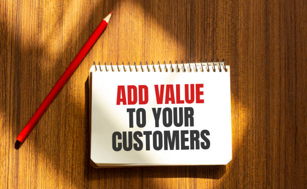 istock Red pen and notepad with text ADD VALUE TO YOUR CUSTOMERS in the white background 1267018674