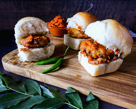 Eggless dinner rolls and batter fried boiled potato balls which are tempered with mustard seeds, ginger, green chilies and curry leaves. Served with red chilies and garlic chutney and sweet tamarind chutney.