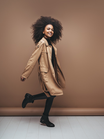 Photo of cheerful curly afro girl with positive emotions
