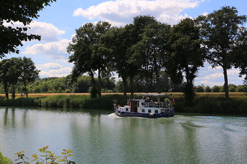 Münster, July 12, 2020: Small motorboat on Sunday afternoon on the Dortmund-Ems Canal near Münster in North Rhine-Westphalia
