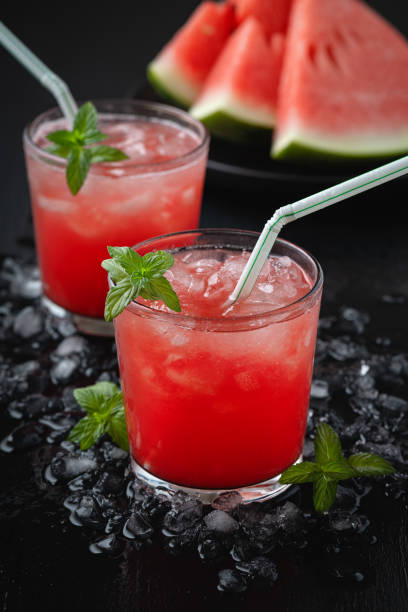 istock Summer cold drink with watermelon and mint on a black wooden background. 1267021107