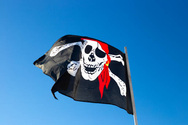 istock pirate flag flies against the blue sky 1267021348