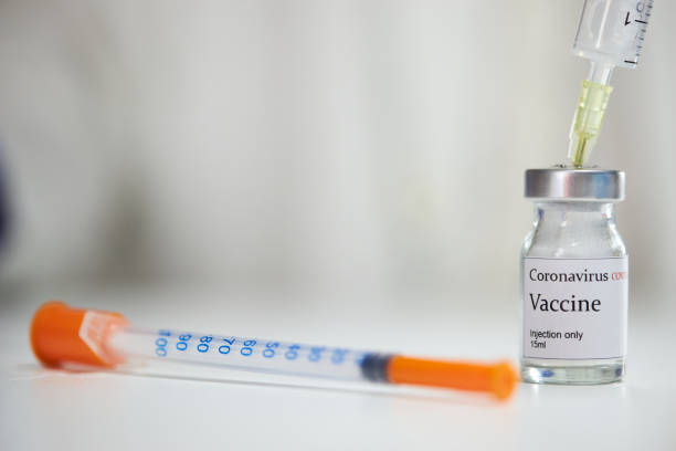 istock COVID-19 vaccine solution with a syringe near it 1267021463