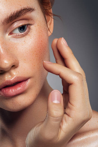 Close-up portrait of beautiful woman with freckles Close-up portrait of beautiful woman with freckles stage makeup women beauty human face stock pictures, royalty-free photos & images