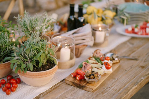 istock Flowers in pots on a festive table with a cutting board on a blurred background. 1267023416