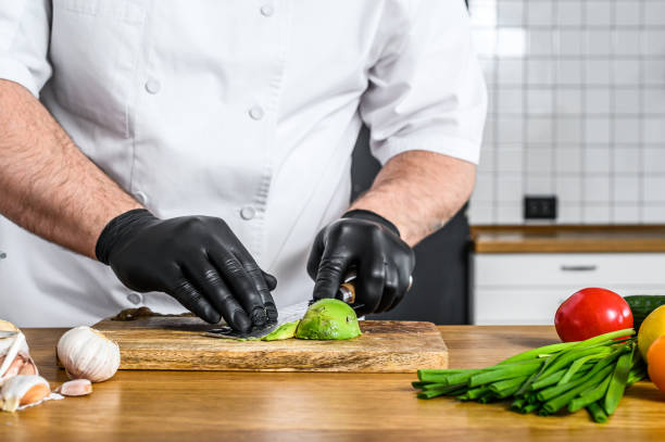 istock A chef in black gloves prepares guacamole from fresh avacado Hass 1267024809
