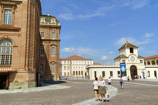 Venaria Reale, Italy - August 8, 2019: the Royal Palace of Venaria was designed by architect Amedeo di Castellamonte in 1675 in Venaria Reale near Turin, Piedmont, Italy. It was first conceived as hunting lodge then was enlarged by architect Filippo Juvarra and became a royal residence for Savoy family. Some people around