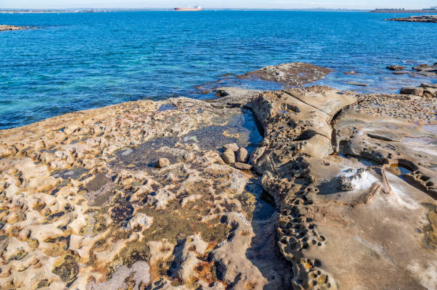 istock Sandstone Shore Platform at Bare Island Fort with Blue Bay Water Background Blur 1267026802