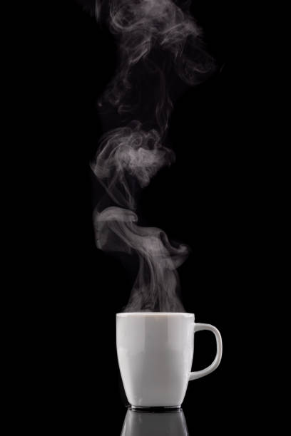 Coffee cup and steam. Freshly brewed coffee in a white ceramic mug. Dark background.