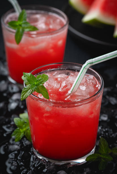istock Summer cold drink with watermelon and mint on a black wooden background. 1267027873