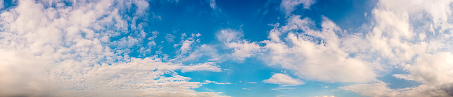 Panorama of a beautiful blue summer sky with fluffy clouds