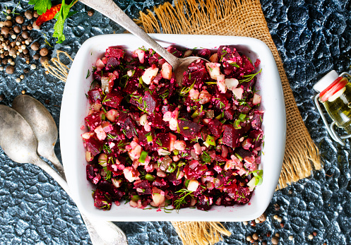beet salad with cucumber and nuts, salad in bowl