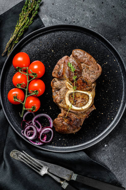 istock Osso buco, cooked Veal shank. Ossobuco meat. Black background. Top view 1267030265