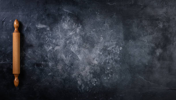 istock Baking background with the rolling pin with flour on the dark table 1267030606