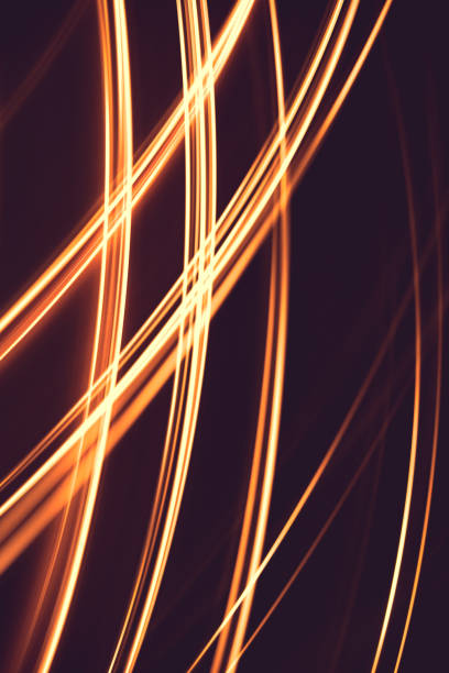 istock Painting with light at night,  bright orange line shape on a black backgroud. The light source moves within the frame. 1267030835