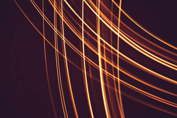 istock Painting with light at night,  bright orange line shape on a black backgroud. The light source moves within the frame. 1267031604