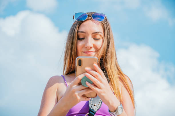 istock Beautiful young woman using her smartphone and texting 1267032848