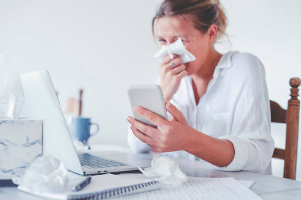 istock Woman with a cold or flu or allergy working at home 1267035984