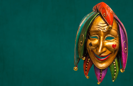 Traditional Venetian mask on the streets of Venice, Italy, isolated on colorful background.